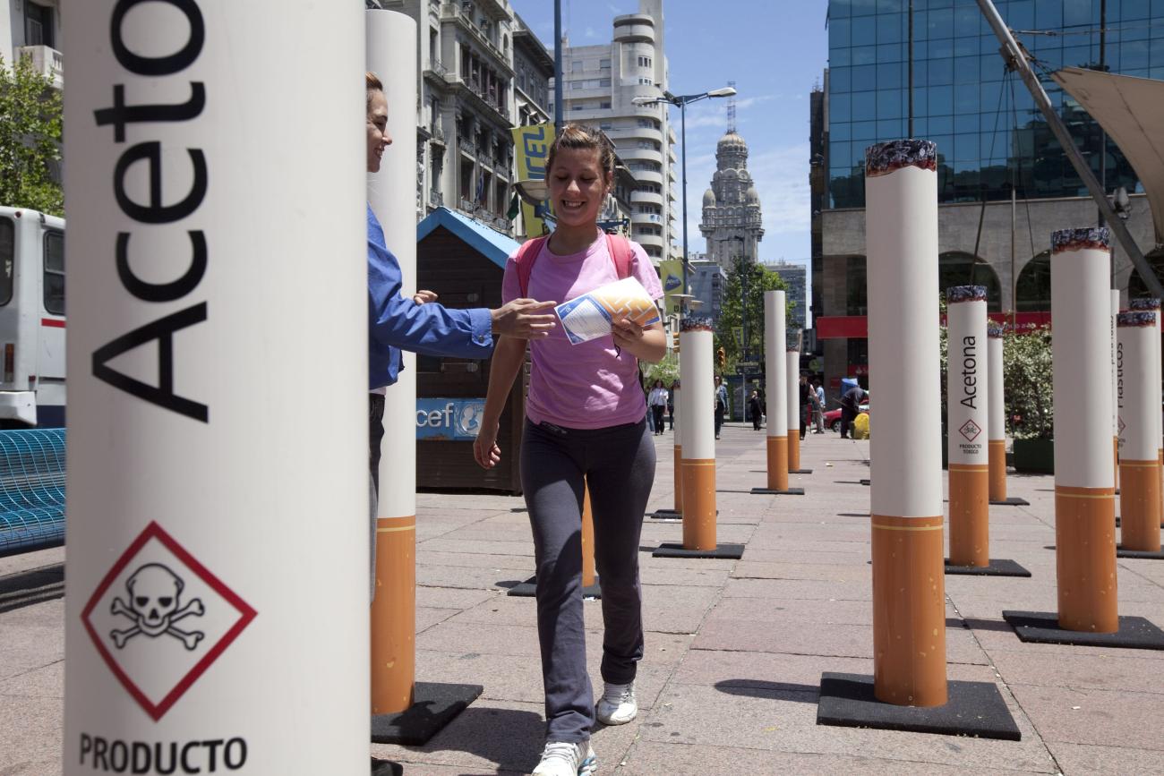 People walk past near an anti-tobacco installation during the Fourth Conference of the Framework Convention on Tobacco Control.