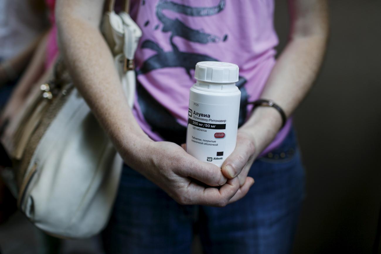 An activist of the All-Ukrainian Network of People Living With HIV/AIDS, a non-governmental group, holds an empty package of the drug Aluvia, as she takes part in a rally in front of the Ukrainian cabinet of ministers building in Kyiv, Ukraine, July 1, 2015. 