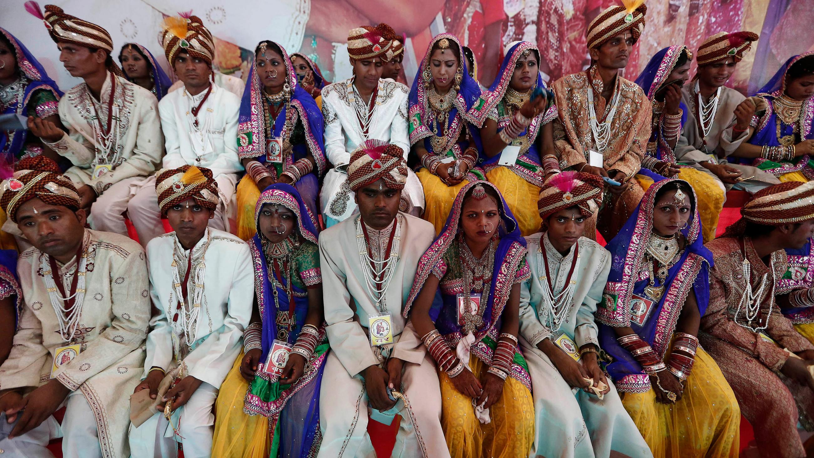 The photo shows a huge number of couples in fancy wedding garb.