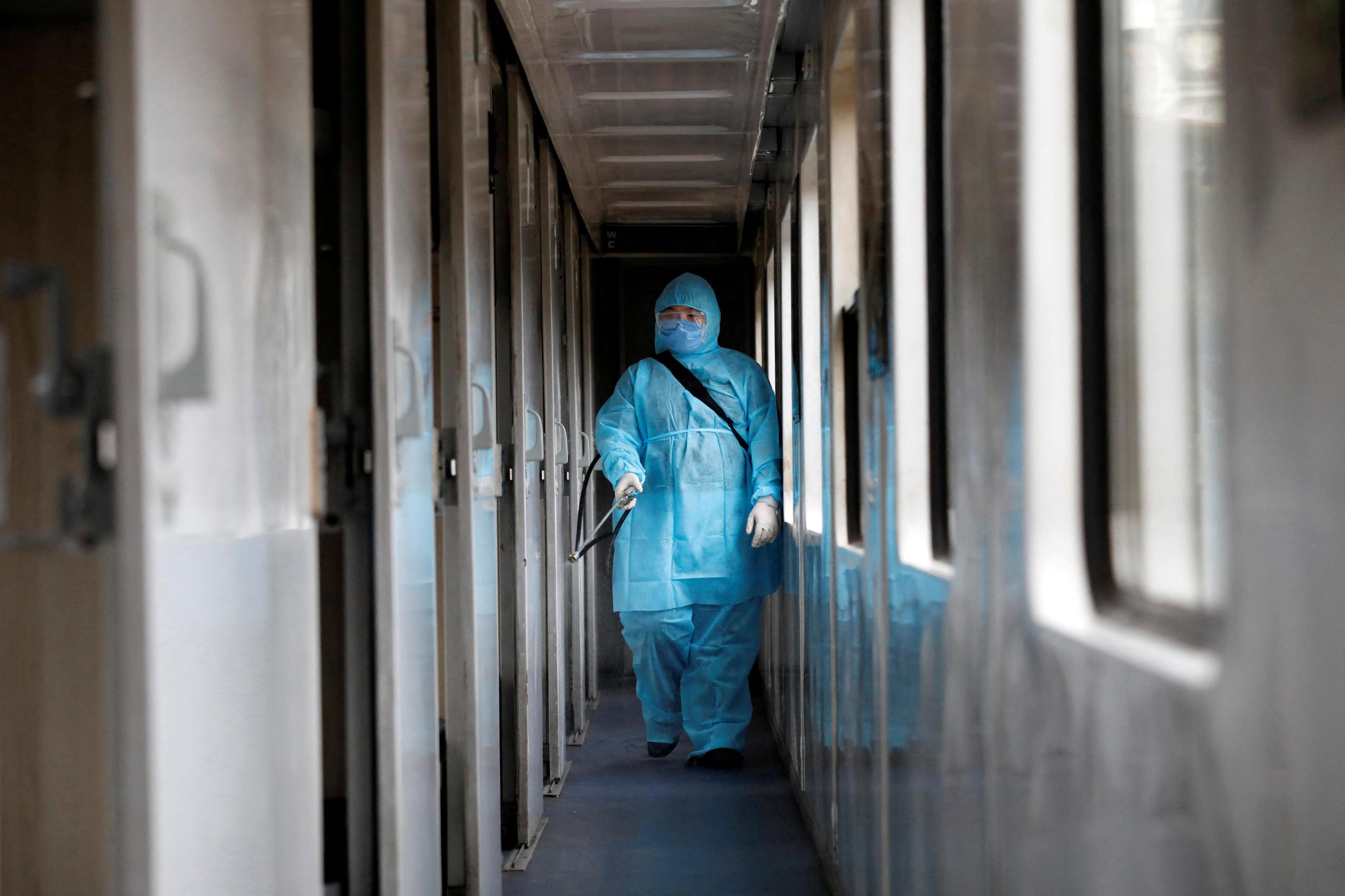 A health worker sprays disinfectants a train as a measure against the COVID-19, in Hanoi, Vietnam, on March 19, 2020.